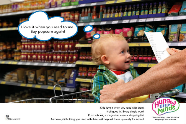 Hungry Little Minds campaign imagery. Baby and parent shopping in a supermarket, text 'I love it when you read to me. Say Popcorn again'. 