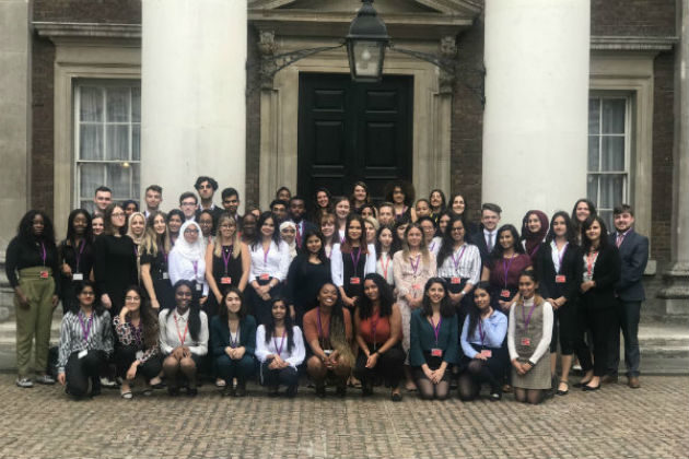 Group of over 30 interns outside a historical building.