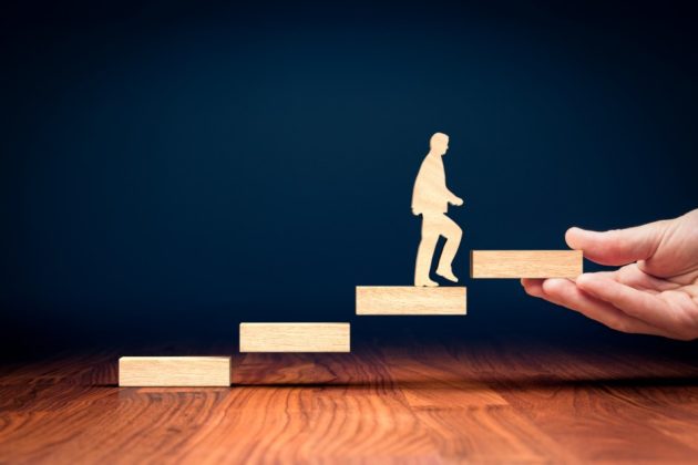 Wooden steps and cartoon figure of a man climbing these steps.