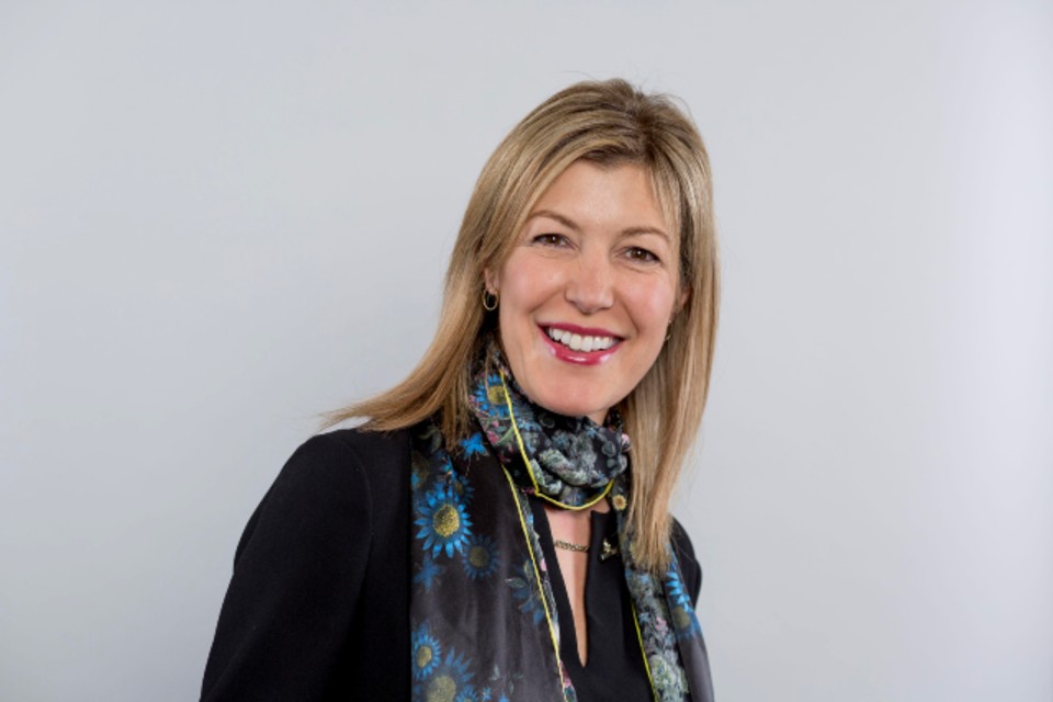 Blond woman smiling.