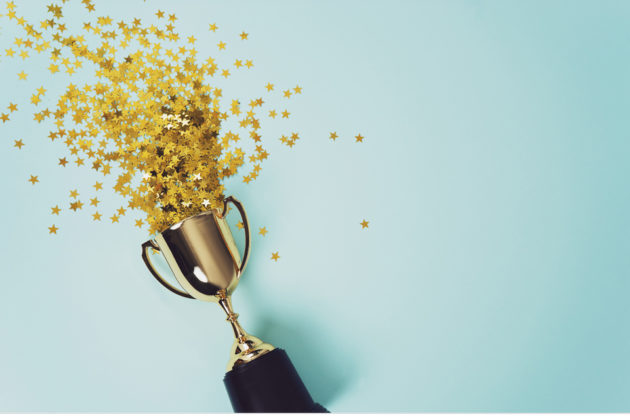 Image to represent winning. A gold trophy with stars.