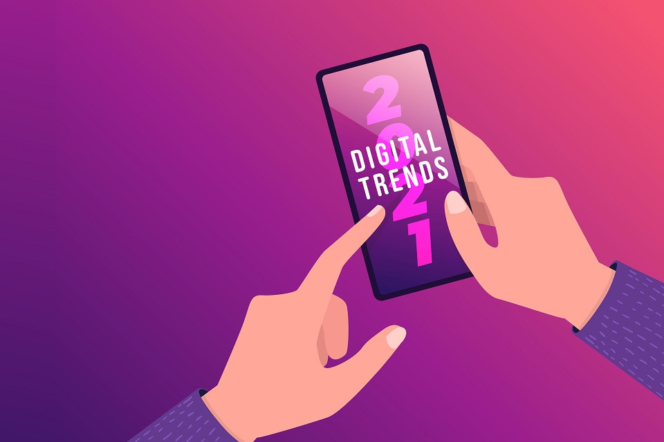 Hand holding mobile with Digital Trends 2021 on screen