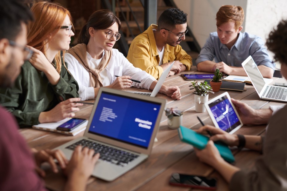 People using laptops at a desk