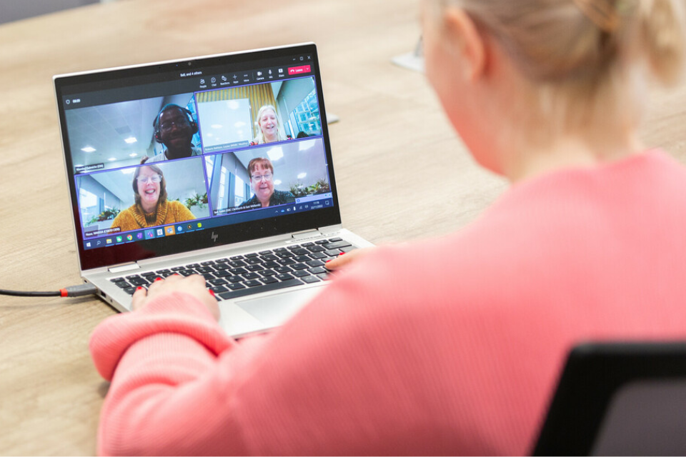 person using laptop joining a virtual meeting