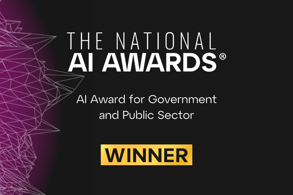 On a black and purple gradient background, which has an opaque geometric pattern, is bold white text in the centre: The National AI Awards. AI Award for Government and Public Sector. Winner. The word ‘Winner’ is in a gold yellow box so it stands out against the black background.