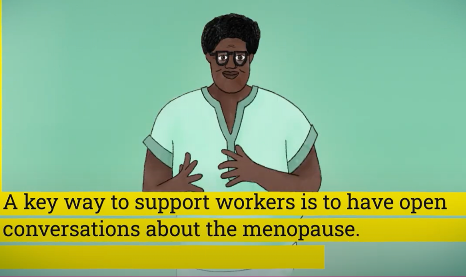 A screenshot of a short youtube video to explain the Menopause and Equality Act. The video is paused on a graphic of a woman explaining the Act, with her hands gesturing, in front of a pale green background. At the bottom of the screen are subtitles written in black text in yellow boxes for each line. The text reads: "A key way to support workers is to have open conversations about the menopause."