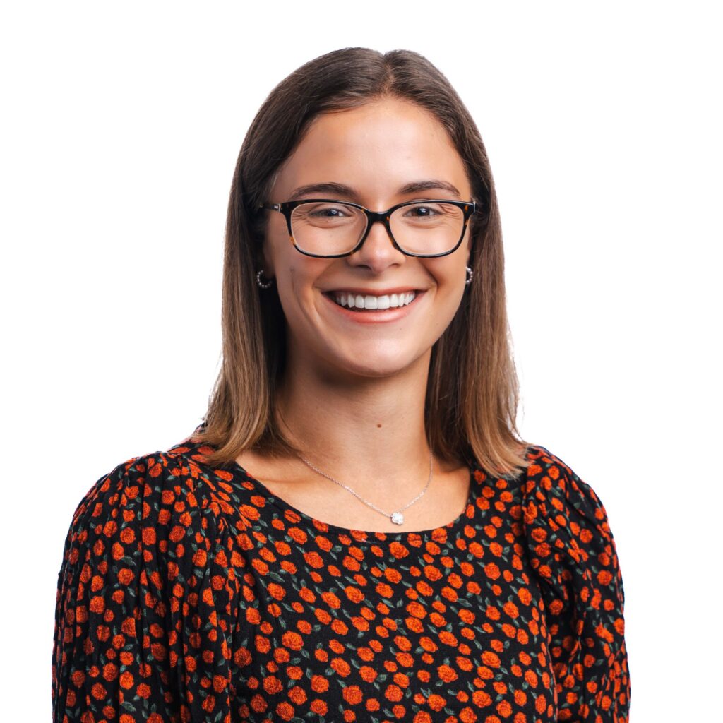Ruby smiling, set against a white background