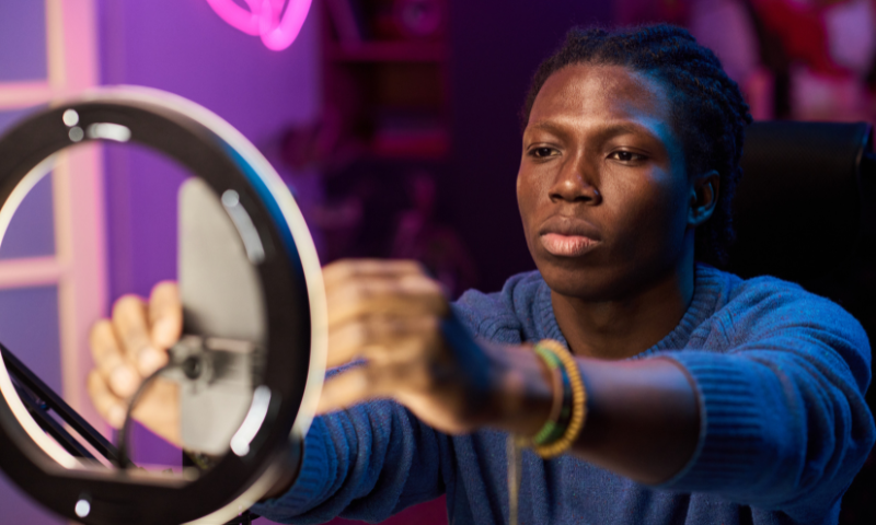 A person adjusts their phone and ring light.