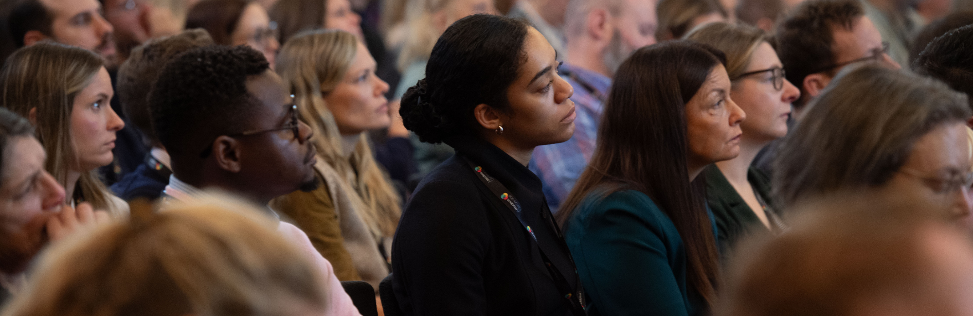 An audience watching a presentation at the front of the room.